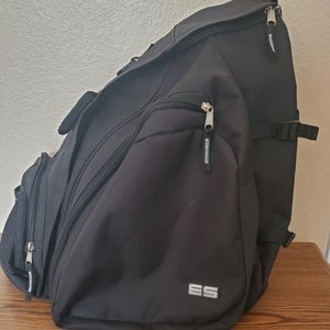 A black sling backpack with 3 storage compartments